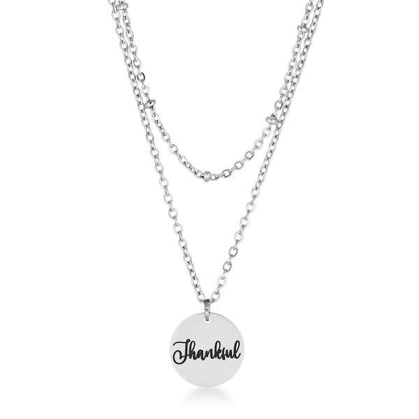 This classy necklace features a simple oval pendant inscribed with THANKFUL hanging from a cable chain. An inner saturn chain adds sophistication to